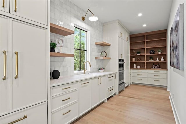 4785 Merlendale Ct, Atlanta, GA 30327 - kitchen with open shelves, a sink, decorative backsplash, white cabinets, and recessed lighting