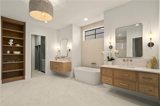 4785 Merlendale Ct, Atlanta, GA 30327 - bathroom with marble finish flooring, a freestanding tub, two vanities, walk in shower, and recessed lighting