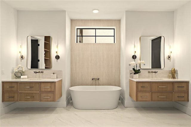 4785 Merlendale Ct, Atlanta, GA 30327 - bathroom featuring marble look tiles, two vanities, and a freestanding tub