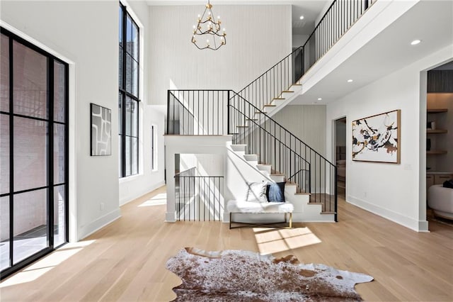 4785 Merlendale Ct, Atlanta, GA 30327 - stairs featuring a high ceiling, wood finished floors, a chandelier, plenty of natural light, and recessed lighting