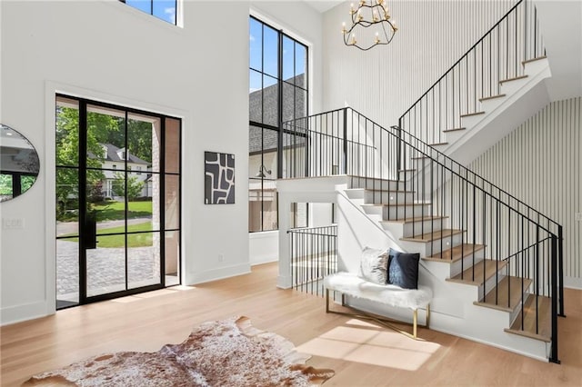 4785 Merlendale Ct, Atlanta, GA 30327 - foyer entrance featuring a high ceiling, wood finished floors, a chandelier, plenty of natural light, and stairway