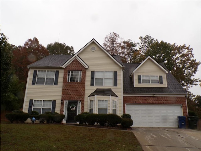 view of front of property featuring a garage and a front yard