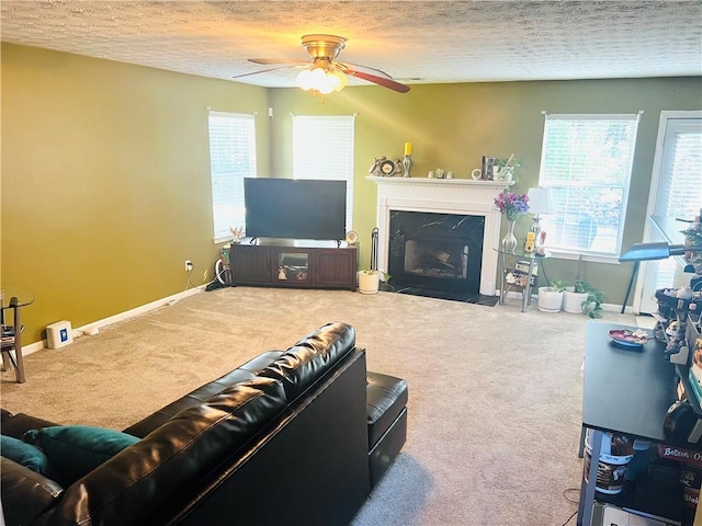 carpeted living room with a textured ceiling and ceiling fan