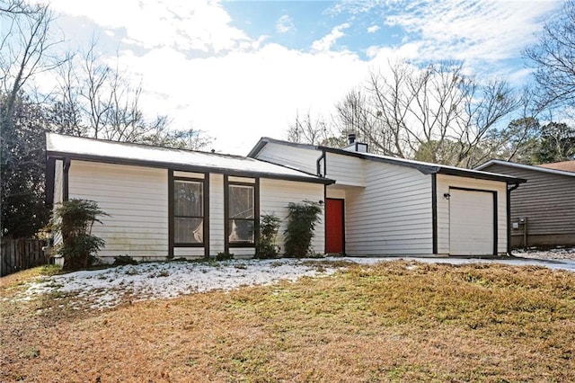 single story home with a front yard and a garage