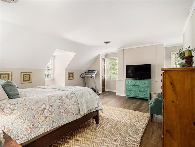 bedroom featuring ornamental molding, light hardwood / wood-style floors, and lofted ceiling