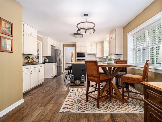 dining room with a chandelier and dark wood-type flooring