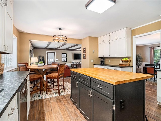 kitchen with white cabinets, light hardwood / wood-style flooring, and a kitchen island