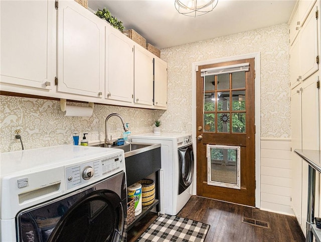 laundry room with cabinets, separate washer and dryer, dark wood-type flooring, and sink