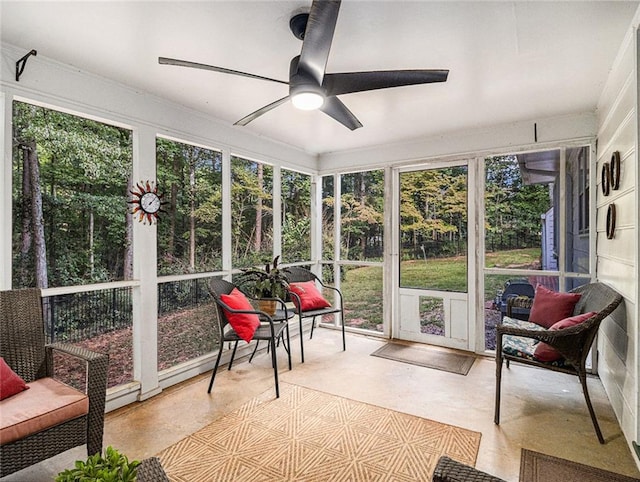 sunroom featuring ceiling fan and a healthy amount of sunlight