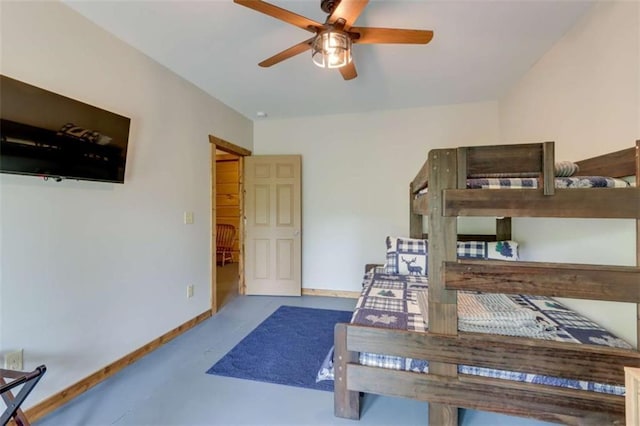 bedroom with finished concrete floors and baseboards