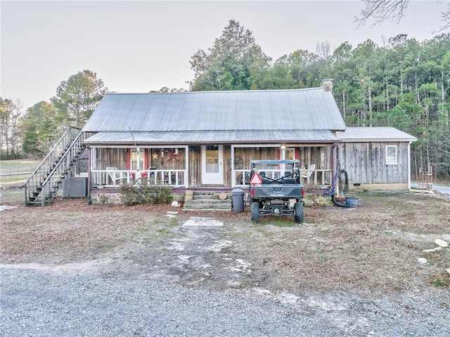 view of front of home with covered porch and cooling unit