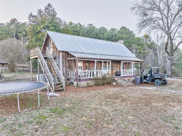 view of front of home featuring a trampoline and covered porch