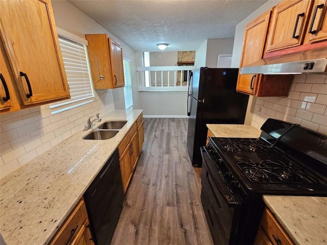 6301 Creekford Dr, Lithonia, GA 30058 - kitchen with tasteful backsplash, a sink, black appliances, and dark wood finished floors