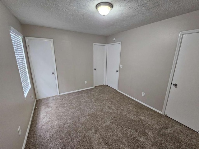 6301 Creekford Dr, Lithonia, GA 30058 - unfurnished bedroom with a textured ceiling, baseboards, and carpet floors