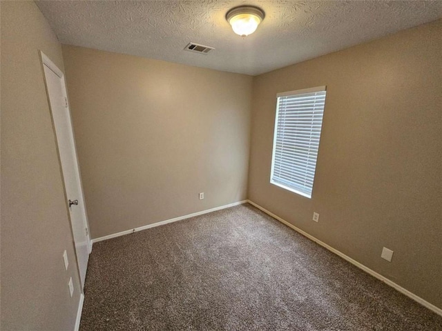 6301 Creekford Dr, Lithonia, GA 30058 - carpeted empty room with visible vents, a textured ceiling, and baseboards