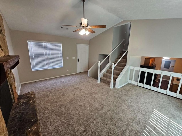 6301 Creekford Dr, Lithonia, GA 30058 - unfurnished living room featuring vaulted ceiling, carpet flooring, stairway, a ceiling fan, and visible vents