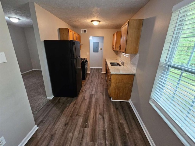 6301 Creekford Dr, Lithonia, GA 30058 - kitchen featuring a sink, a textured ceiling, black appliances, and brown cabinets