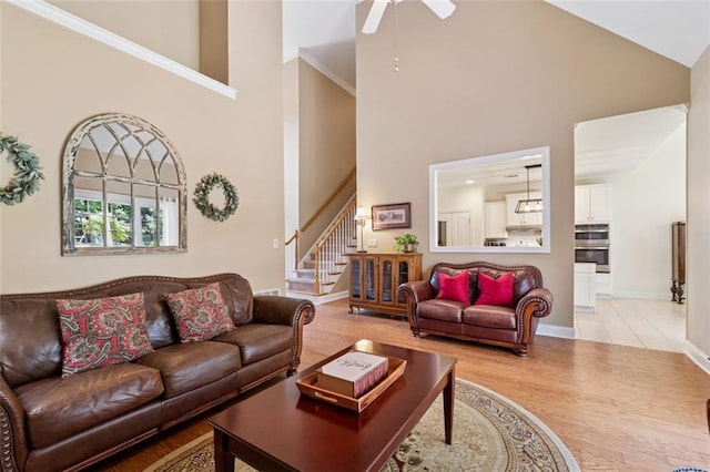 1125 Fairview Club Cir, Dacula, GA 30019 - living area featuring high vaulted ceiling, stairs, a ceiling fan, and wood finished floors