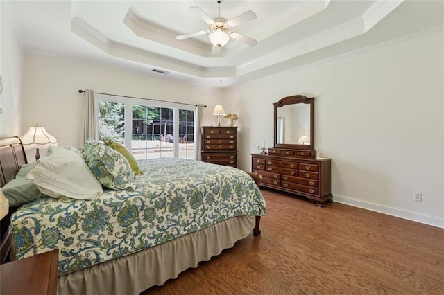 1125 Fairview Club Cir, Dacula, GA 30019 - bedroom featuring crown molding, a raised ceiling, wood finished floors, and a ceiling fan