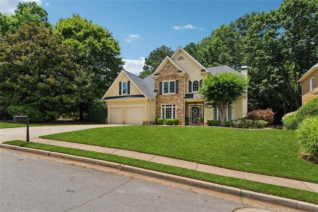 1125 Fairview Club Cir, Dacula, GA 30019 - view of front of property featuring driveway, a front lawn, a chimney, and an attached garage