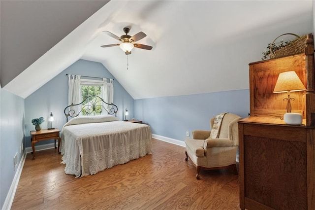 1125 Fairview Club Cir, Dacula, GA 30019 - bedroom featuring wood finished floors, vaulted ceiling, and a ceiling fan