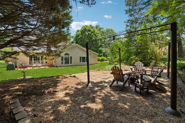 1125 Fairview Club Cir, Dacula, GA 30019 - view of grassy yard featuring an outdoor fire pit and a patio area