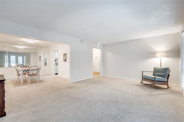 sitting room with light carpet, visible vents, and baseboards