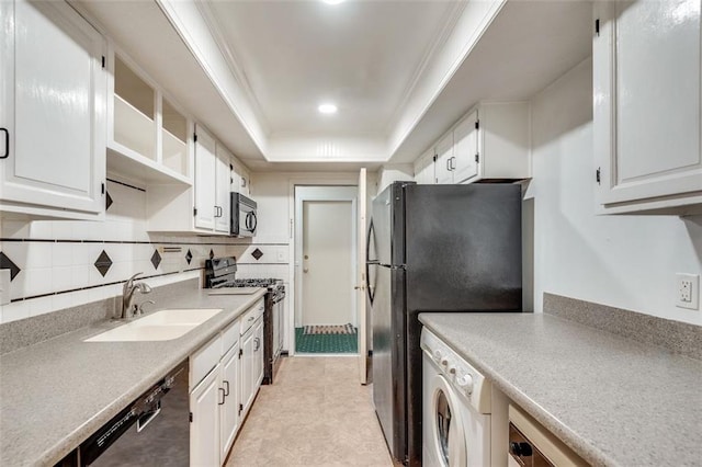 kitchen featuring black microwave, dishwashing machine, a sink, washer / clothes dryer, and gas range