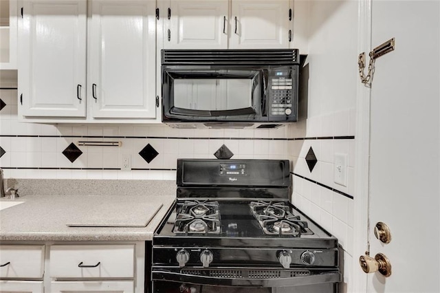 kitchen with decorative backsplash, light countertops, white cabinetry, and black appliances