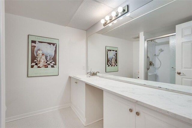 bathroom featuring toilet, vanity, baseboards, a shower stall, and tile patterned floors