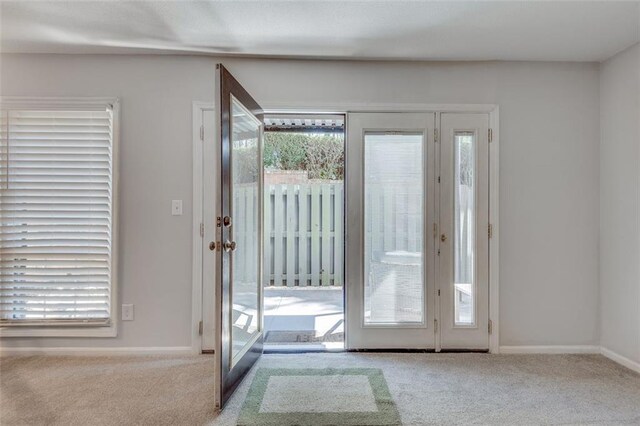 entryway with carpet flooring and baseboards