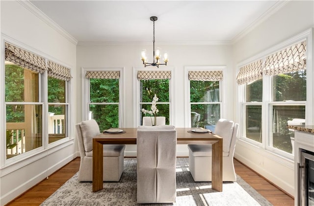 4679 Glenshire Pl, Dunwoody, GA 30338 - dining area with a chandelier, healthy amount of natural light, wood finished floors, and ornamental molding