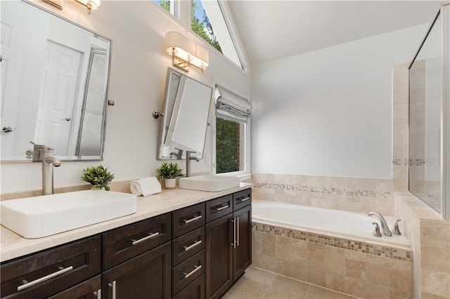4679 Glenshire Pl, Dunwoody, GA 30338 - bathroom featuring a bath, double vanity, high vaulted ceiling, and tile patterned flooring
