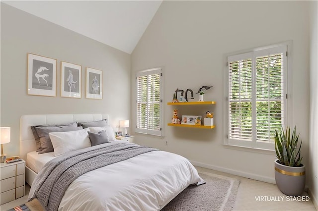 4679 Glenshire Pl, Dunwoody, GA 30338 - bedroom with multiple windows, light colored carpet, baseboards, and high vaulted ceiling