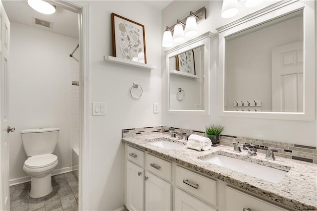 4679 Glenshire Pl, Dunwoody, GA 30338 - full bathroom with double vanity, toilet, baseboards,  shower combination, and tasteful backsplash