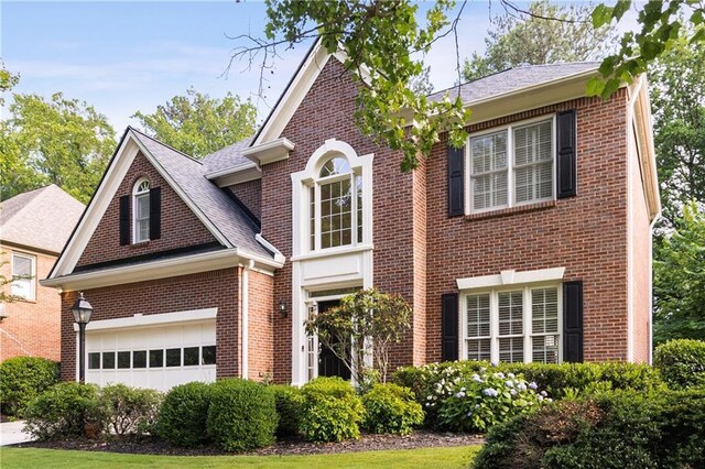 4679 Glenshire Pl, Dunwoody, GA 30338 - view of front of home with brick siding, a garage, and a shingled roof