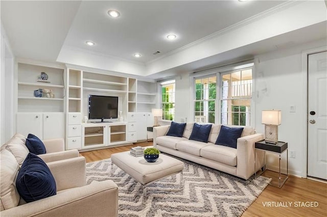4679 Glenshire Pl, Dunwoody, GA 30338 - living room featuring ornamental molding, wood finished floors, a raised ceiling, built in shelves, and recessed lighting
