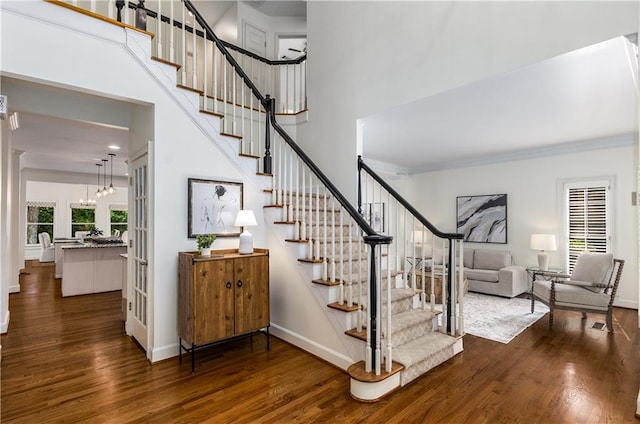 4679 Glenshire Pl, Dunwoody, GA 30338 - staircase with wood finished floors, a high ceiling, baseboards, and crown molding