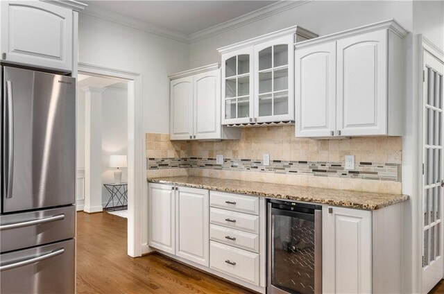 4679 Glenshire Pl, Dunwoody, GA 30338 - kitchen with freestanding refrigerator, wine cooler, wood finished floors, glass insert cabinets, and white cabinetry