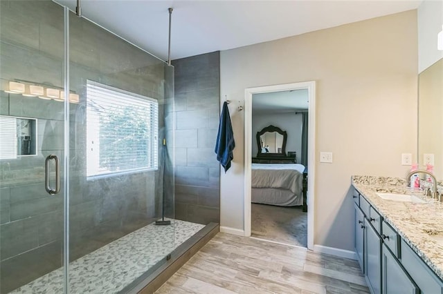 bathroom featuring an enclosed shower, vanity, and hardwood / wood-style flooring