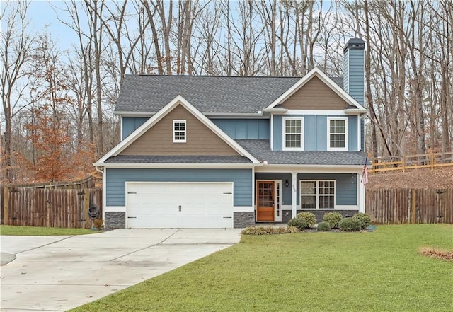 craftsman-style home featuring a front yard and a garage