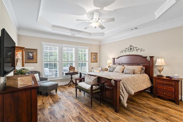 218 Begonia Ct, Griffin, GA 30223 - bedroom featuring wood finished floors, a tray ceiling, ornamental molding, and ceiling fan