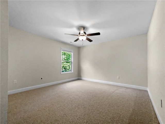 empty room with ceiling fan and carpet