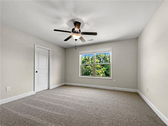 carpeted spare room with ceiling fan