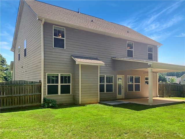 back of house featuring a yard and a patio area