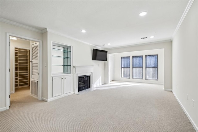 unfurnished living room featuring crown molding, recessed lighting, light colored carpet, a fireplace with flush hearth, and baseboards