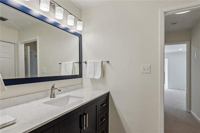 bathroom featuring visible vents, vanity, and baseboards