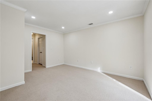 spare room featuring recessed lighting, light carpet, crown molding, and baseboards