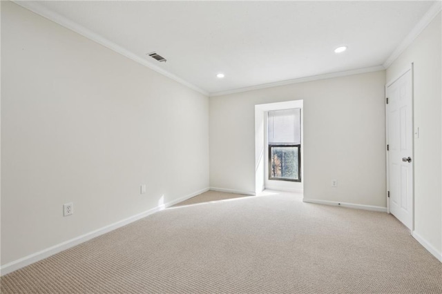 unfurnished room featuring light carpet, ornamental molding, visible vents, and baseboards