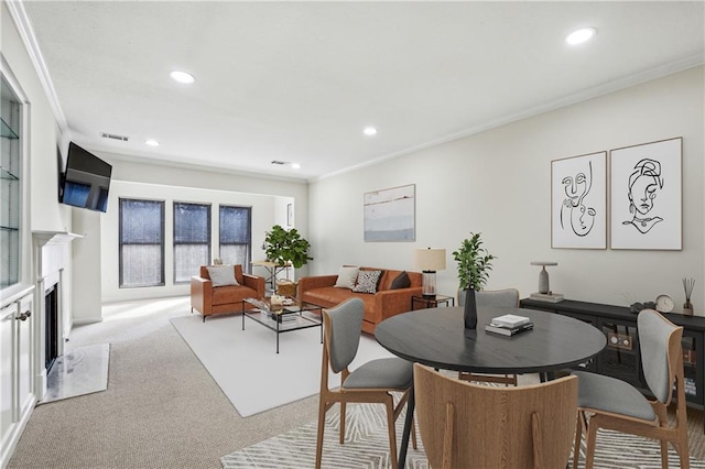 dining area featuring recessed lighting, a fireplace, light colored carpet, and crown molding